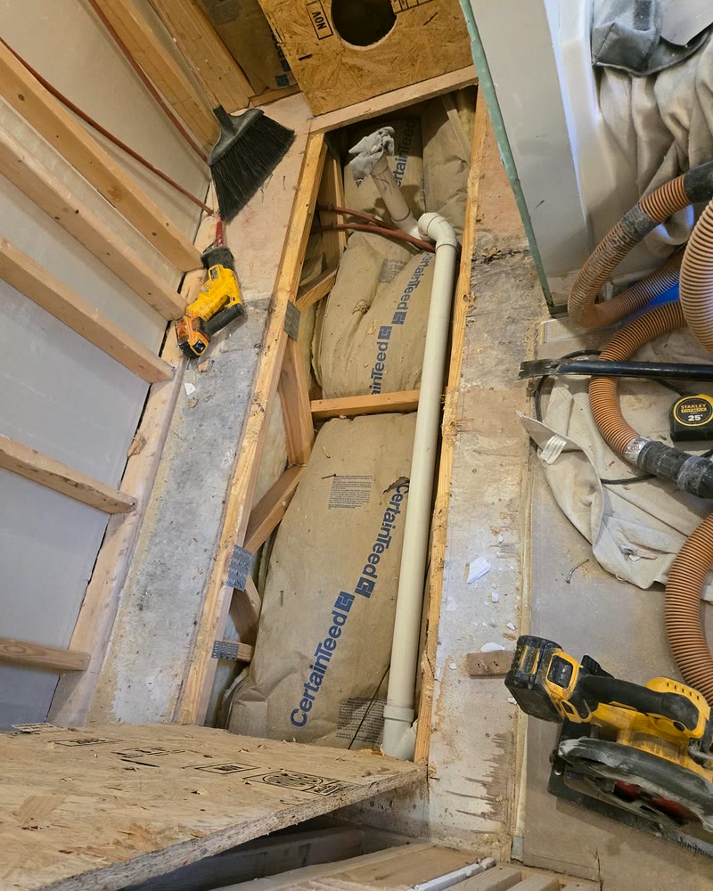 Plumbing rough-in with new drain line and valve set in the open wall