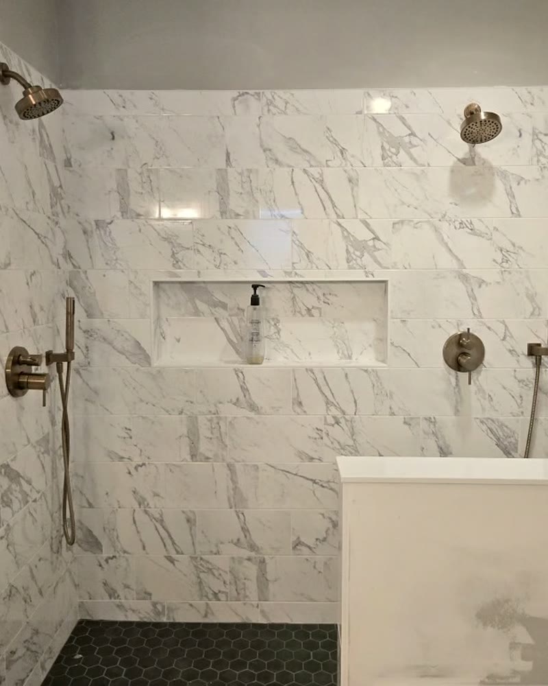 The tiled shower with the niche and second shower head installed
