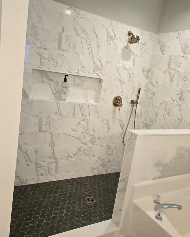 Finished tile with the half wall and garden tub alongside