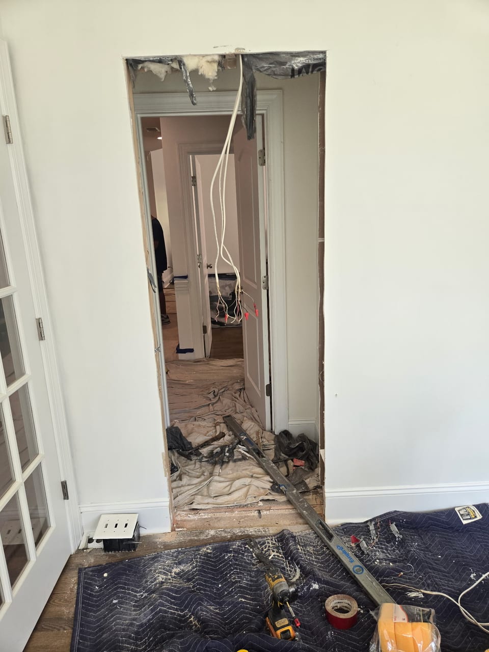 Damaged drywall being torn out during the tear-down