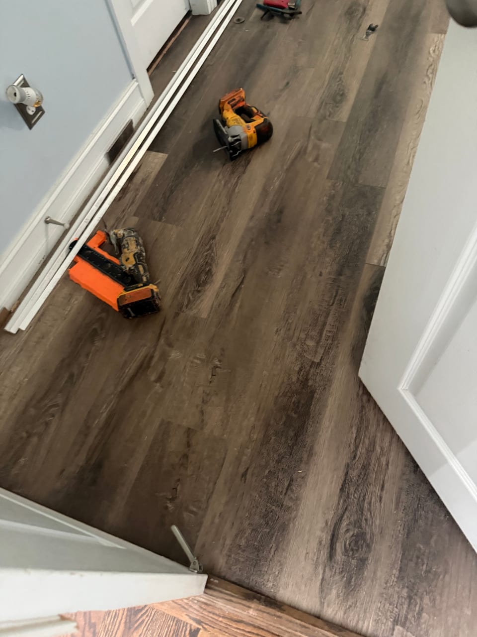 Luxury vinyl plank being installed across the room